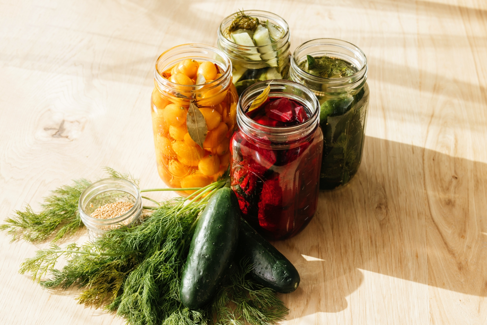 a group of jars filled with different types of vegetables.