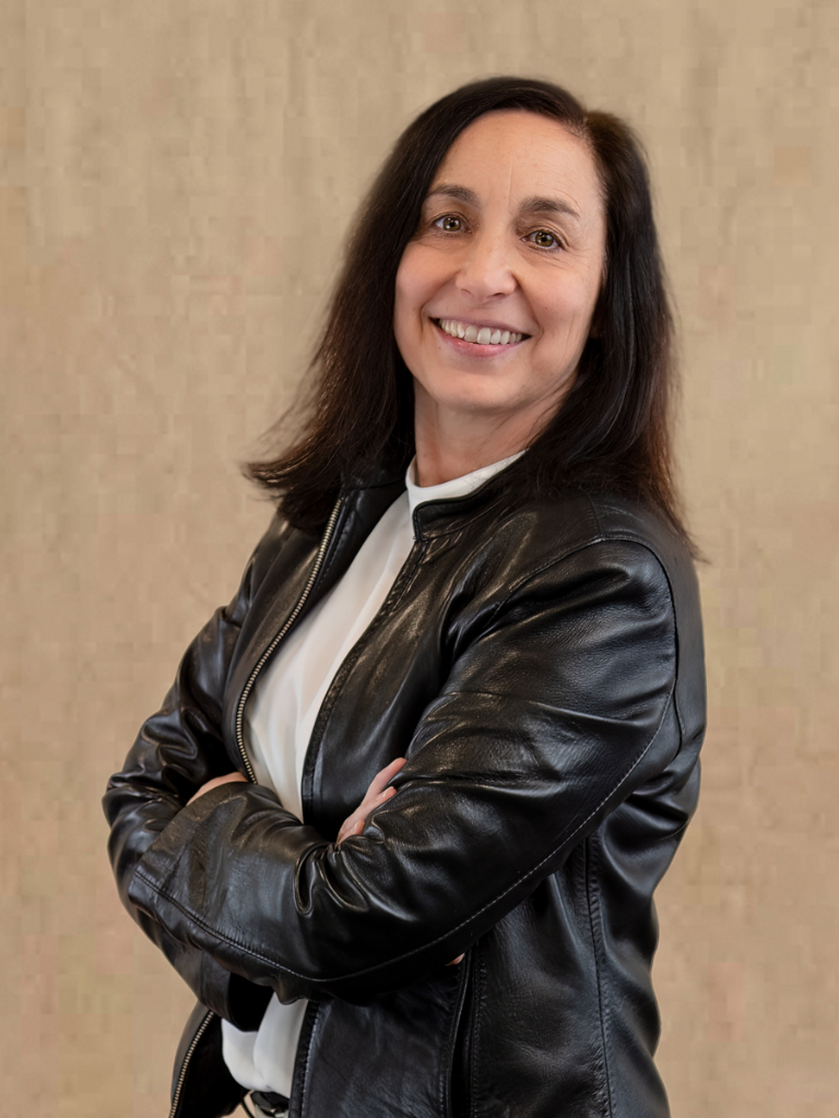 a woman in a black leather jacket posing for a picture.