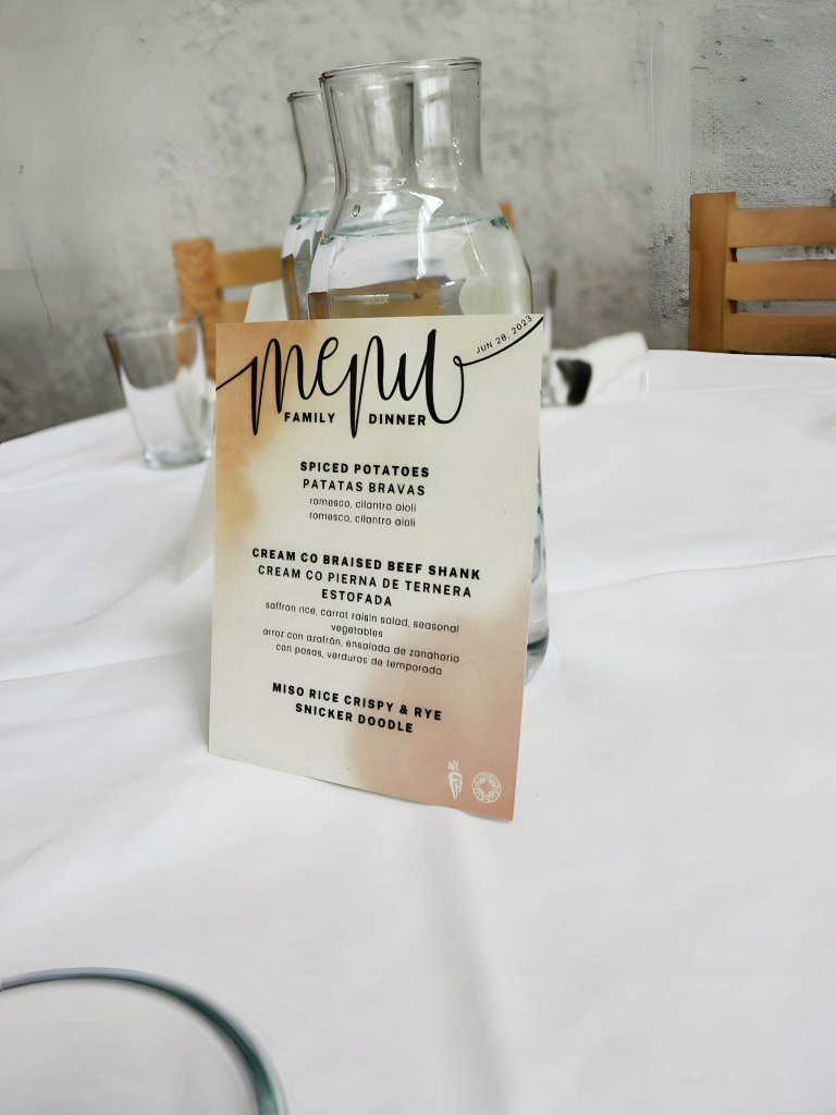 a table setting with a menu on it.